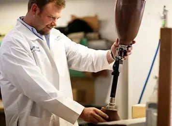 technician fabricating prosthetic limb