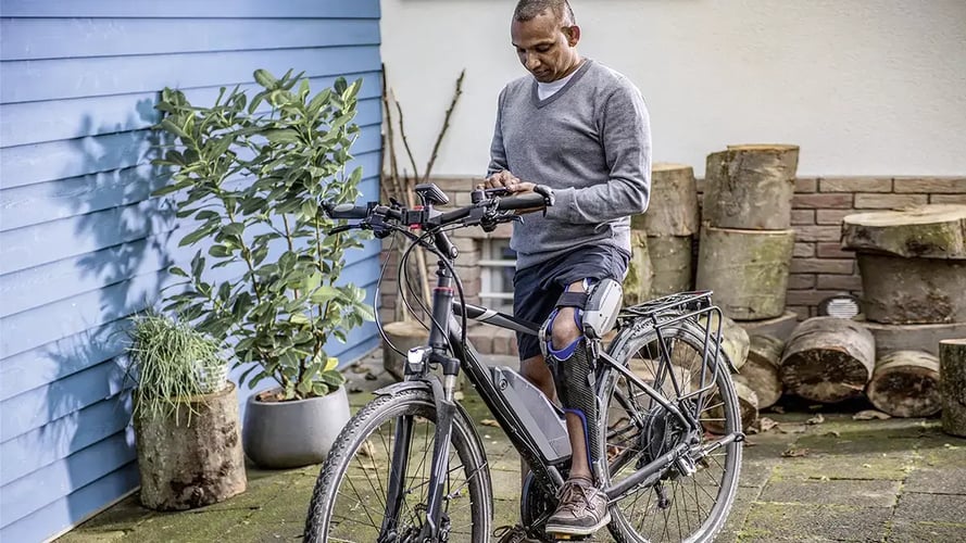 man on bike with orthotic brace 1200x675