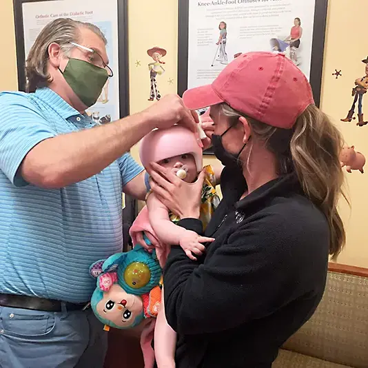 fitting pediatric patient with cranial helmet