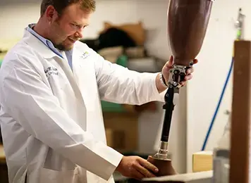 technician fabricating prosthetic limb