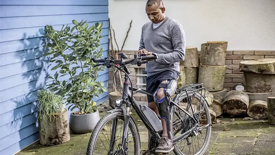 man on bike with orthotic brace 890x501 V2